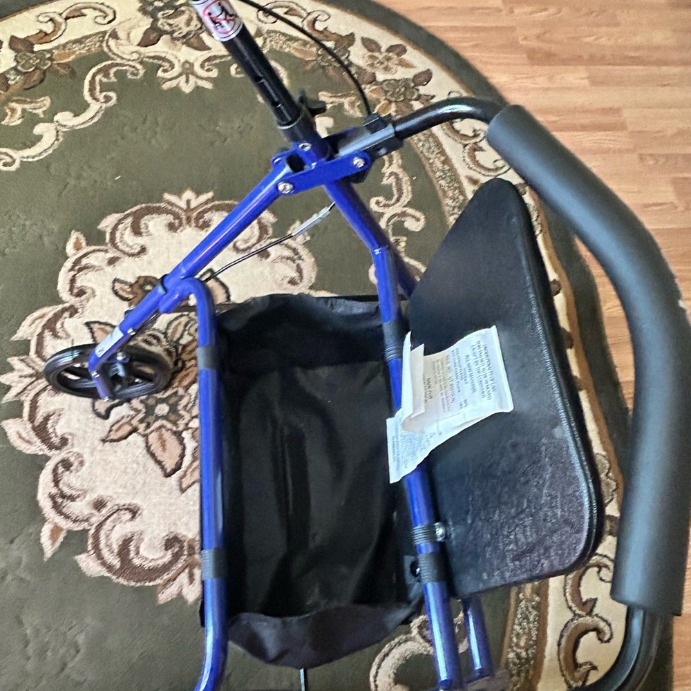 Walker in new condition has seat that flips up for storage department.